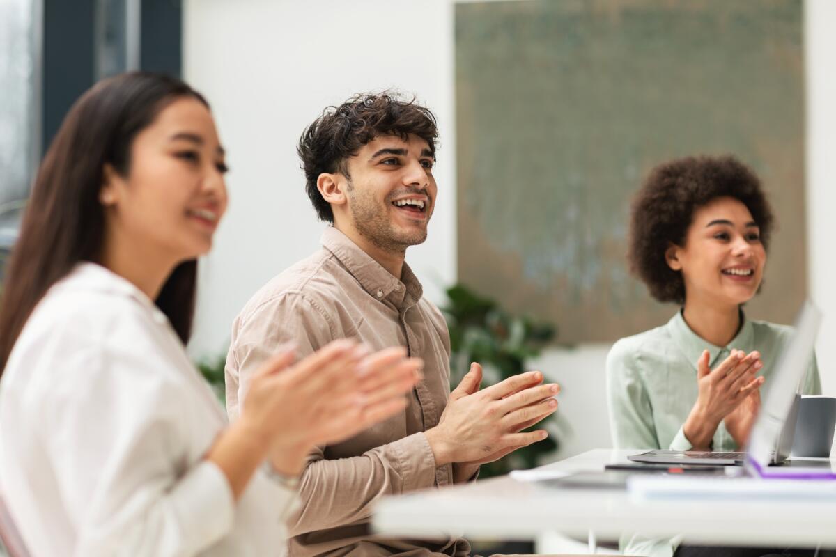 Group Of Joyful Business People Clapping Hands Sitting In Office