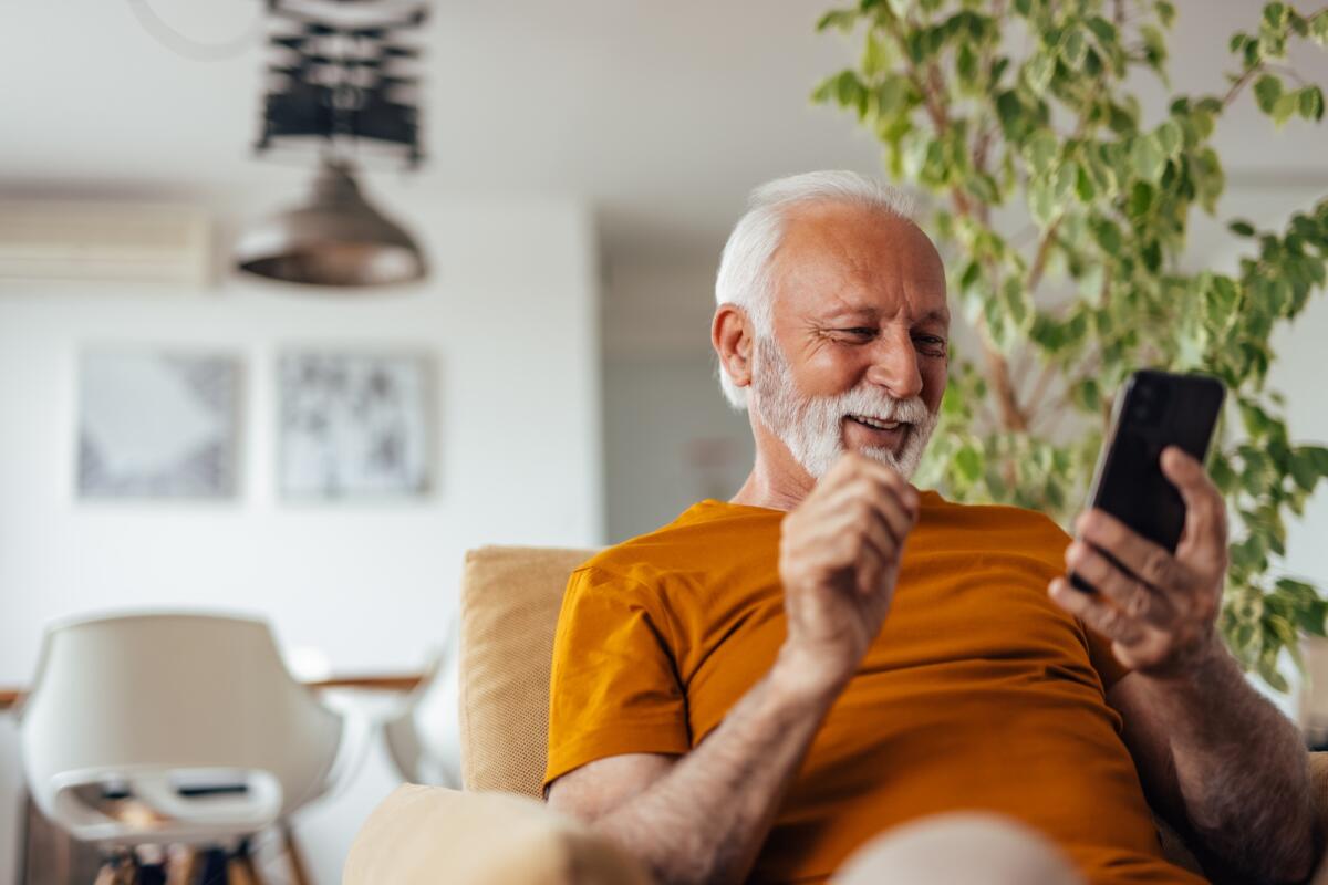Senior man, typing a birthday message.