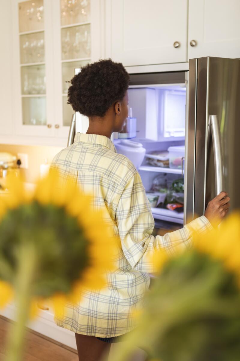 Woman opening the fridge